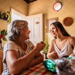 Two people talking at a kitchen table